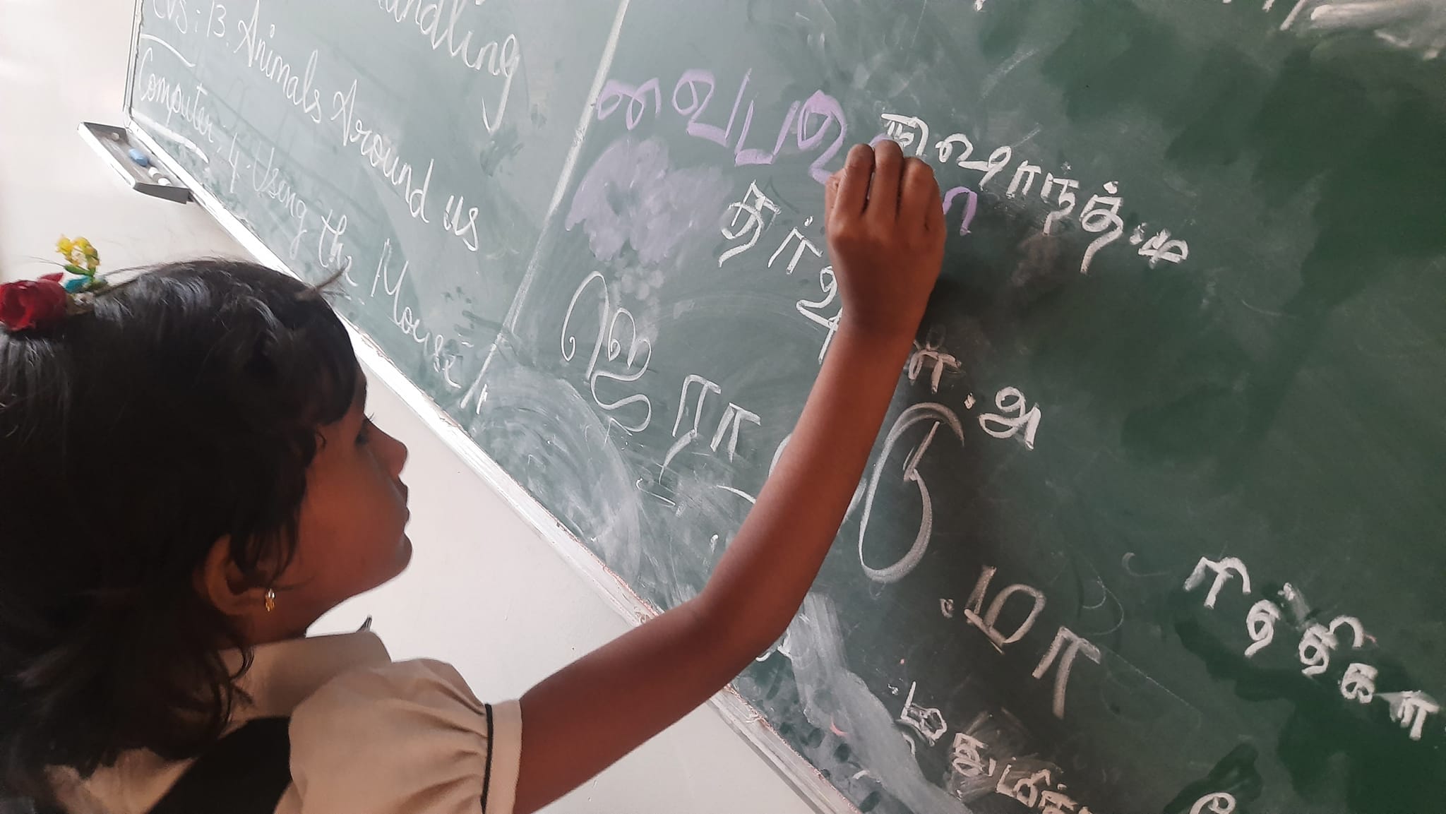 Students writing their name on board